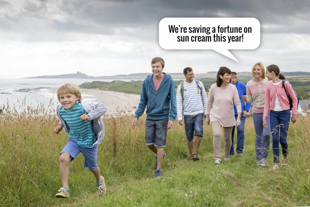 A group of people walking down a grassy hill.
