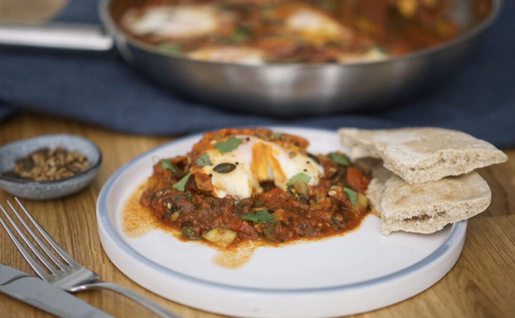 A plate with eggs and vegetables on it.
